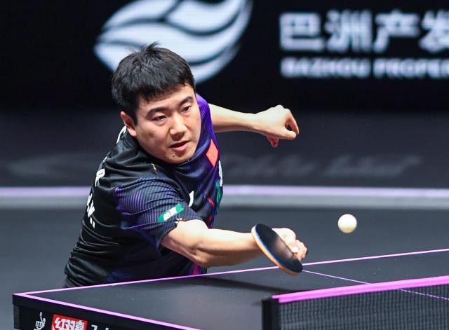 (260312) -- CHONGQING, March 12, 2026 (Xinhua) -- Liang Jingkun hits a return during the men's singles round of 32 match between Liang Jingkun of China and Xiang Peng of China at the WTT Champions Chongqing 2026 in southwest China's Chongqing, March 12, 2026. (Xinhua/Tang Yi)