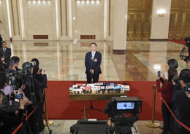 (260312) -- BEIJING, March 12, 2026 (Xinhua) -- China's Minister of Natural Resources Guan Zhiou gives an interview after the closing meeting of the fourth session of the 14th National People's Congress (NPC) at the Great Hall of the People in Beijing, capital of China, March 12, 2026. (Xinhua/Wang Xi)