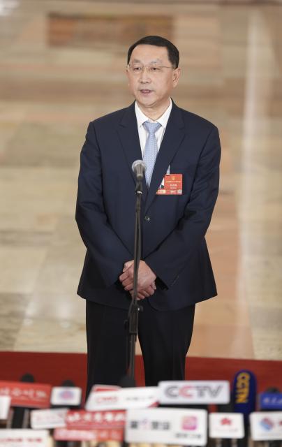 (260312) -- BEIJING, March 12, 2026 (Xinhua) -- China's Minister of Natural Resources Guan Zhiou gives an interview after the closing meeting of the fourth session of the 14th National People's Congress (NPC) at the Great Hall of the People in Beijing, capital of China, March 12, 2026. (Xinhua/Wang Xi)