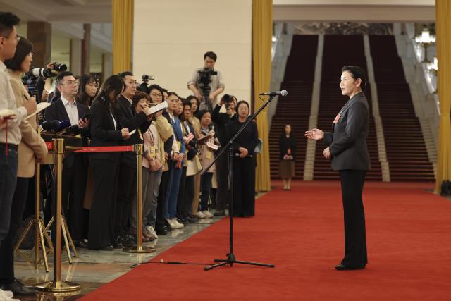 (260312) -- BEIJING, March 12, 2026 (Xinhua) -- China's Minister of Justice He Rong gives an interview after the closing meeting of the fourth session of the 14th National People's Congress (NPC) at the Great Hall of the People in Beijing, capital of China, March 12, 2026. (Xinhua/Jin Liwang)
