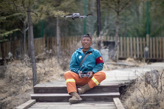 (260312) -- LHASA, March 12, 2026 (Xinhua) -- Tashi Chophel operates a drone to patrol the mountains at Nanshan Park in Lhasa, southwest China's Xizang Autonomous Region, March 20, 2025.
  TO GO WITH "Xizang Story: Ranger's 14-year watch over greening mountain on 'roof of world'" (Xinhua/Jiang Fan)