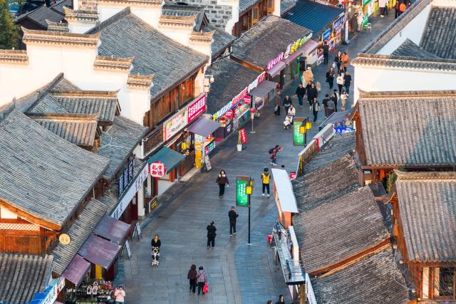 (260312) -- CHANGSHA, March 12, 2026 (Xinhua) -- An aerial drone photo shows people visiting Changde Hejie along the Chuanzi River in Changde, central China's Hunan Province, March 11, 2026.
  The once heavily polluted Chuanzi River, which meanders through the city proper of Changde, has now become a clean and attractive scenic spot along its banks. Boasting a long history, the riverside Changde Hejie old street has been transformed into a historical and cultural block. (Xinhua/Chen Sihan)
