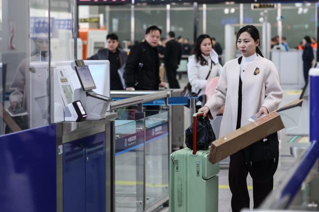(260312) -- DANDONG, March 12, 2026 (Xinhua) -- A passenger from the Democratic People's Republic of Korea (DPRK) goes through customs clearance at the Dandong Railway Station in Dandong, northeast China's Liaoning Province, March 12, 2026. An international passenger train linking Dandong in northeast China's Liaoning Province with Pyongyang, capital of the Democratic People's Republic of Korea (DPRK), began service on Thursday.
   The passenger service will operate daily in both directions. (Xinhua/Pan Yulong)