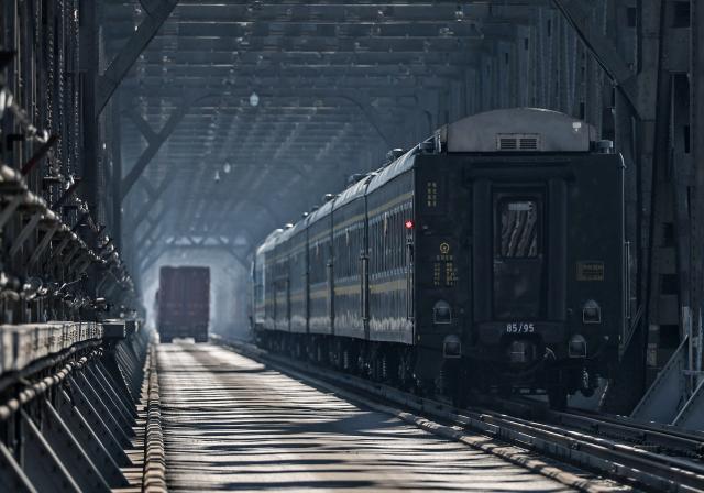 (260312) -- DANDONG, March 12, 2026 (Xinhua) -- The train No. 95 from Dandong of China to Pyongyang of the Democratic People's Republic of Korea (DPRK) passes a border bridge in Dandong, northeast China's Liaoning Province, March 12, 2026. An international passenger train linking Dandong in northeast China's Liaoning Province with Pyongyang, capital of the Democratic People's Republic of Korea (DPRK), began service on Thursday.
   The passenger service will operate daily in both directions. (Xinhua/Pan Yulong)