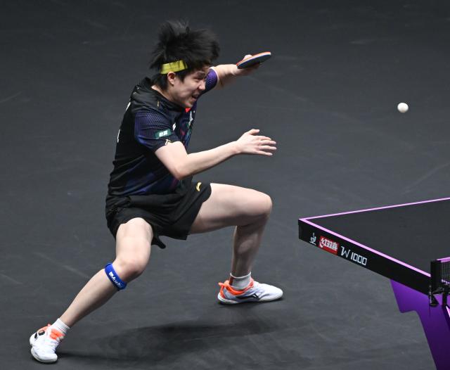 (260312) -- CHONGQING, March 12, 2026 (Xinhua) -- Wang Chuqin of China hits a return during the men's singles round of 16 match against Patrick Franziska of Germany at the WTT Champions Chongqing 2026 in southwest China's Chongqing, March 12, 2026. (Xinhua/Chen Cheng)