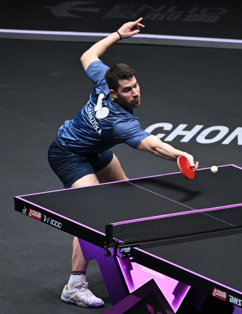 (260312) -- CHONGQING, March 12, 2026 (Xinhua) -- Patrick Franziska of Germany hits a return during the men's singles round of 16 match against Wang Chuqin of China at the WTT Champions Chongqing 2026 in southwest China's Chongqing, March 12, 2026. (Xinhua/Chen Cheng)