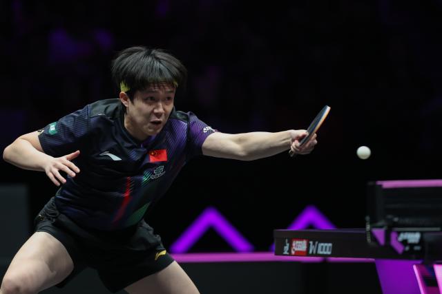 (260312) -- CHONGQING, March 12, 2026 (Xinhua) -- Wang Chuqin of China hits a return during the men's singles round of 16 match against Patrick Franziska of Germany at the WTT Champions Chongqing 2026 in southwest China's Chongqing, March 12, 2026. (Xinhua/Huang Wei)