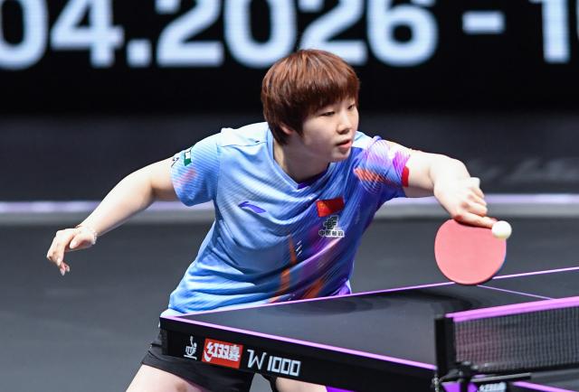 (260312) -- CHONGQING, March 12, 2026 (Xinhua) -- Kuai Man of China hits a return during the women's singles round of 16 match against Bruna Takahashi of Brazil at the WTT Champions Chongqing 2026 in southwest China's Chongqing, March 12, 2026. (Xinhua/Tang Yi)