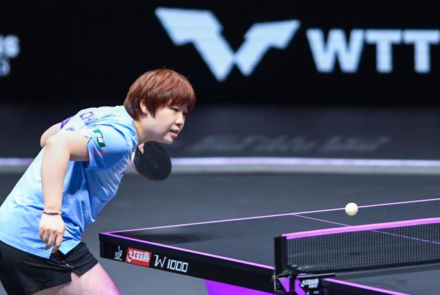 (260312) -- CHONGQING, March 12, 2026 (Xinhua) -- Kuai Man of China hits a return during the women's singles round of 16 match against Bruna Takahashi of Brazil at the WTT Champions Chongqing 2026 in southwest China's Chongqing, March 12, 2026. (Xinhua/Tang Yi)