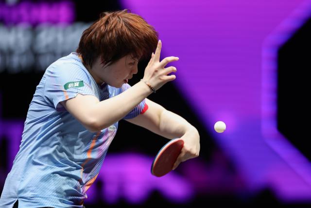 (260312) -- CHONGQING, March 12, 2026 (Xinhua) -- Kuai Man of China hits a return during the women's singles round of 16 match against Bruna Takahashi of Brazil at the WTT Champions Chongqing 2026 in southwest China's Chongqing, March 12, 2026. (Xinhua/Huang Wei)