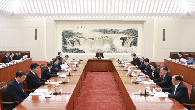 (260312) -- BEIJING, March 12, 2026 (Xinhua) -- Zhao Leji, executive chairman of the presidium of the fourth session of the 14th National People's Congress (NPC) and chairman of the NPC Standing Committee, presides over the third meeting of executive chairpersons of the presidium at the Great Hall of the People in Beijing, capital of China, March 12, 2026. (Xinhua/Ding Haitao)