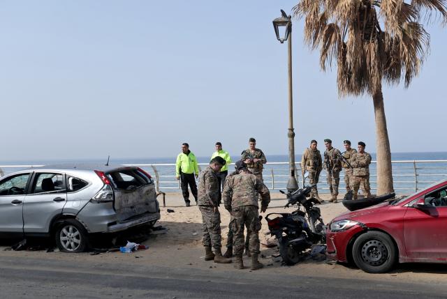 (260312) -- BEIRUT, March 12, 2026 (Xinhua) -- This photo taken on March 12, 2026 shows Lebanese army soldiers and police inspecting the site hit by an Israeli airstrike in the Ramlet al-Baida area of Beirut, Lebanon. At least 11 people were killed and 32 injured in Israeli airstrikes targeting areas in and around the Lebanese capital early Thursday, said Lebanon's health ministry. (Photo by Bilal Jawich/Xinhua)