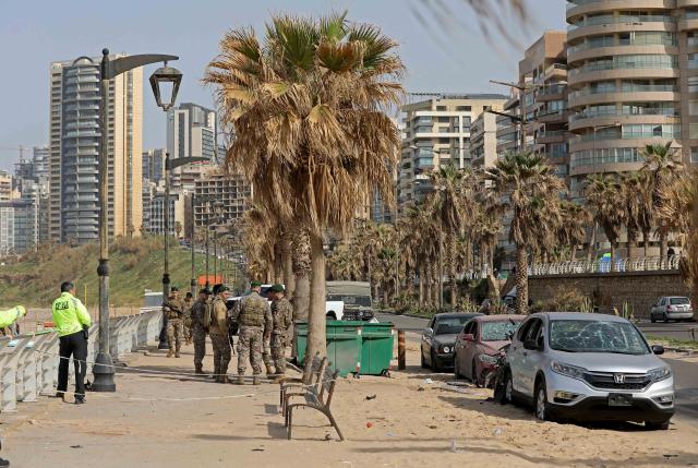 (260312) -- BEIRUT, March 12, 2026 (Xinhua) -- This photo taken on March 12, 2026 shows Lebanese army soldiers and police inspecting the site hit by an Israeli airstrike in the Ramlet al-Baida area of Beirut, Lebanon. At least 11 people were killed and 32 injured in Israeli airstrikes targeting areas in and around the Lebanese capital early Thursday, said Lebanon's health ministry. (Photo by Bilal Jawich/Xinhua)