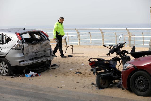 (260312) -- BEIRUT, March 12, 2026 (Xinhua) -- This photo taken on March 12, 2026 shows a Lebanese police officer inspecting the site hit by an Israeli airstrike in the Ramlet al-Baida area of Beirut, Lebanon. At least 11 people were killed and 32 injured in Israeli airstrikes targeting areas in and around the Lebanese capital early Thursday, said Lebanon's health ministry. (Photo by Bilal Jawich/Xinhua)