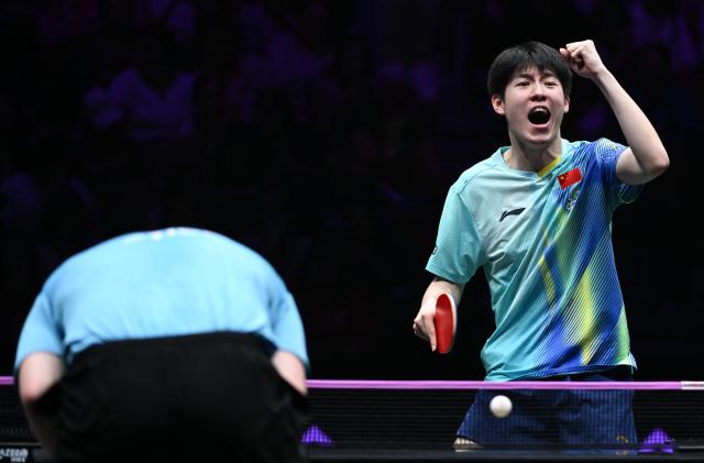 (260312) -- CHONGQING, March 12, 2026 (Xinhua) -- Wen Ruibo celebrates socring during the men's singles round of 16 match between Wen Ruibo of China and Truls Moregard of Sweden at the WTT Champions Chongqing 2026 in southwest China's Chongqing, March 12, 2026. (Xinhua/Chen Cheng)