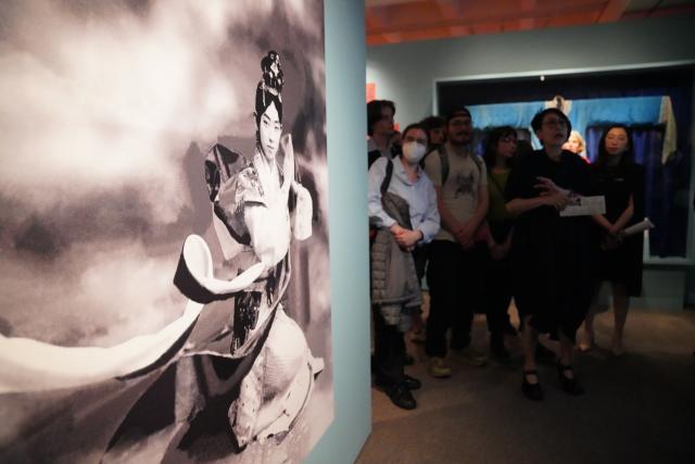 (260312) -- NEW YORK, March 12, 2026 (Xinhua) -- People visit an exhibition titled "The Dancing Goddess: Mei Lanfang in America" in New York, the United States, on March 11, 2026. The exhibition, featuring stage costumes, photographs, performance videos, original production props, and artwork of China's renowned Peking Opera artist Mei Lanfang, opened here on Wednesday to mark the 96th anniversary of his 1930 North American tour. (Xinhua/Zhang Fengguo)