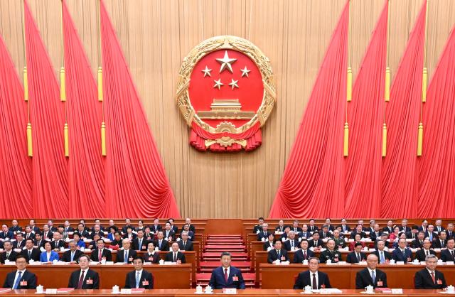 (260312) -- BEIJING, March 12, 2026 (Xinhua) -- The 14th National People's Congress (NPC) holds the closing meeting of its fourth session at the Great Hall of the People in Beijing, capital of China, March 12, 2026. Chinese President Xi Jinping and other leaders including Li Qiang, Wang Huning, Cai Qi, Ding Xuexiang, Li Xi and Han Zheng attended the meeting. (Xinhua/Xie Huanchi)
