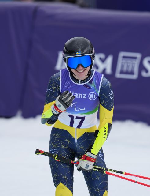 (260312) -- CORTINA D'AMPEZZO, March 12, 2026 (Xinhua) -- Ebba Aarsjoe of Sweden reacts after women's giant slalom standing of the para alpine skiing event at the Milan-Cortina 2026 Paralympic Winter Games in Cortina D'ampezzo, Italy, March 12, 2026. (Xinhua/Mu Yu)