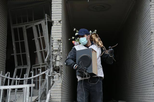 (260312) -- TEHRAN, March 12, 2026 (Xinhua) -- A man searches for daily necessities from damaged buildings in Tehran, Iran, March 12, 2026. (Xinhua/Shadati)