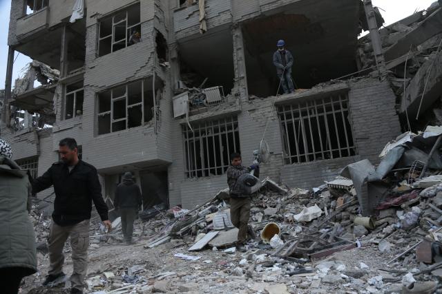 (260312) -- TEHRAN, March 12, 2026 (Xinhua) -- People search for daily necessities from damaged buildings in Tehran, Iran, March 12, 2026. (Xinhua/Shadati)