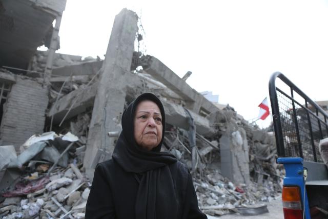 (260312) -- TEHRAN, March 12, 2026 (Xinhua) -- A woman stands in front of damaged buildings in Tehran, Iran, March 12, 2026. (Xinhua/Shadati)