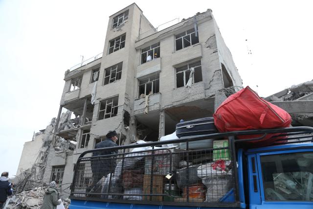 (260312) -- TEHRAN, March 12, 2026 (Xinhua) -- People search for daily necessities from damaged buildings in Tehran, Iran, March 12, 2026. (Xinhua/Shadati)