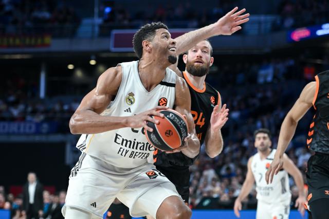 (260313) -- MADRID, March 13, 2026 (Xinhua) -- Real Madrid's Edy Tavares (L) vies with Valencia's Matthew Costello during the Euroleague basketball match between Real Madrid and Valencia in Madrid, Spain, on March 12, 2026. (Photo by Gustavo Valiente/Xinhua)