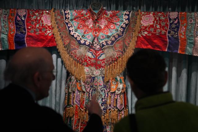(260312) -- BEIJING, March 13, 2026 (Xinhua) -- People visit an exhibition titled "The Dancing Goddess: Mei Lanfang in America" in New York, the United States, on March 11, 2026. The exhibition, featuring stage costumes, photographs, performance videos, original production props, and artwork of China's renowned Peking Opera artist Mei Lanfang, opened here on Wednesday to mark the 96th anniversary of his 1930 North American tour. (Xinhua/Zhang Fengguo)