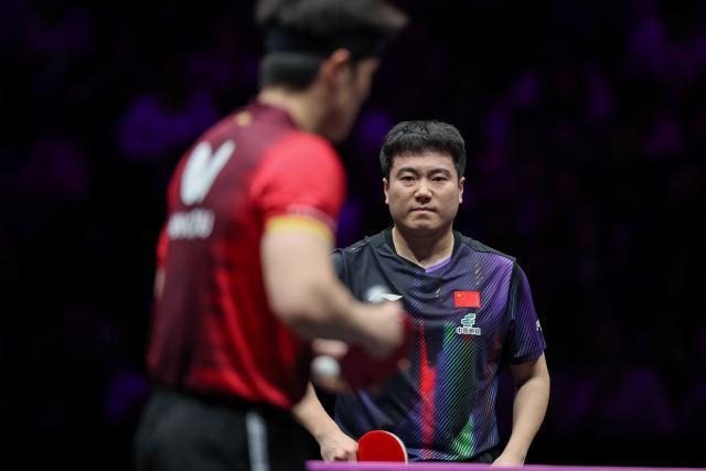(260313) -- CHONGQING, March 13, 2026 (Xinhua) -- Liang Jingkun (R) reacts during the men's singles round of 16 match between Liang Jingkun of China and Qiu Dang of Germany at the WTT Champions Chongqing 2026 in southwest China's Chongqing, March 13, 2026. (Xinhua/Huang Wei)