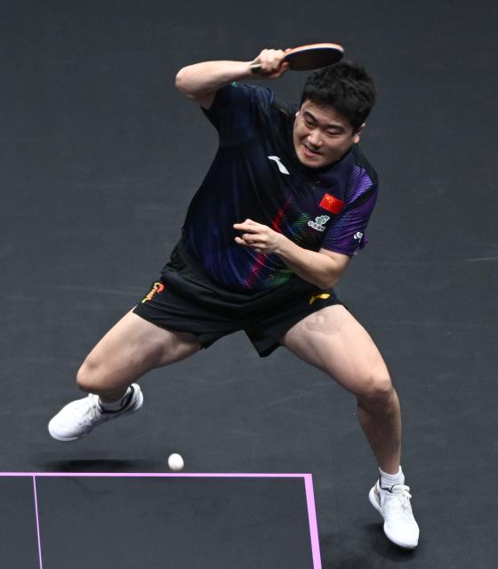 (260313) -- CHONGQING, March 13, 2026 (Xinhua) -- Liang Jingkun hits a return during the men's singles round of 16 match between Liang Jingkun of China and Qiu Dang of Germany at the WTT Champions Chongqing 2026 in southwest China's Chongqing, March 13, 2026. (Xinhua/Chen Cheng)