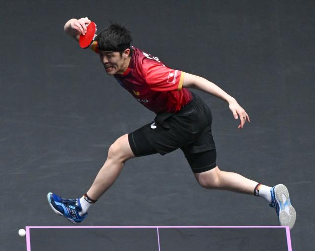 (260313) -- CHONGQING, March 13, 2026 (Xinhua) -- Qiu Dang hits a return during the men's singles round of 16 match between Liang Jingkun of China and Qiu Dang of Germany at the WTT Champions Chongqing 2026 in southwest China's Chongqing, March 13, 2026. (Xinhua/Chen Cheng)