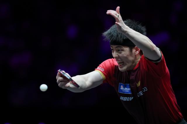(260313) -- CHONGQING, March 13, 2026 (Xinhua) -- Qiu Dang hits a return during the men's singles round of 16 match between Liang Jingkun of China and Qiu Dang of Germany at the WTT Champions Chongqing 2026 in southwest China's Chongqing, March 13, 2026. (Xinhua/Huang Wei)