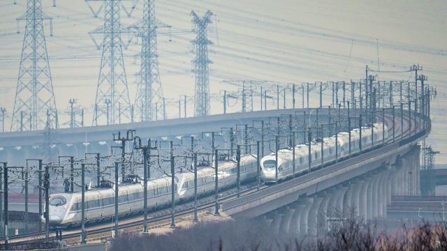 (260313) -- BEIJING, March 13, 2026 (Xinhua) -- A drone photo taken on March 13, 2026 shows two bullet trains running on a railway bridge in north China's Tianjin. The 2026 Spring Festival travel rush comes to an end on Friday. (Photo by Du Penghui/Xinhua)