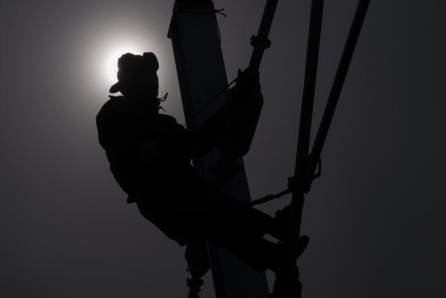 (260313) -- HARBIN, March 13, 2026 (Xinhua) -- A worker installs catenary systems at the construction site of Suihua South Station of the Harbin-Yichun high-speed railway in Suihua, northeast China's Heilongjiang Province, March 13, 2026. Workers from China Railway Wuhan Electrification Bureau Group are pressing ahead with the construction of the communication, signaling and power supply systems for the 318-kilometer Harbin-Yichun high-speed railway. At present, 90% of the project has been completed. (Xinhua/Zhang Tao)
