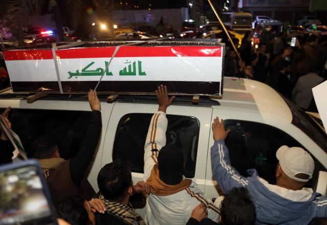 (260313) -- BAGHDAD, March 13, 2026 (Xinhua) -- People attend a funeral for deceased Iraqi paramilitary Popular Mobilization Forces (PMF) members in Baghdad, Iraq, on March 12, 2026. Airstrikes on the 19th Brigade headquarters in Akashat near the Syrian border in Iraq's Anbar province killed at least 32 personnel belonging to the PMF and wounded 65 others on Thursday Morning, a provincial security source told Xinhua on condition of anonymity. (Xinhua/Khalil Dawood)