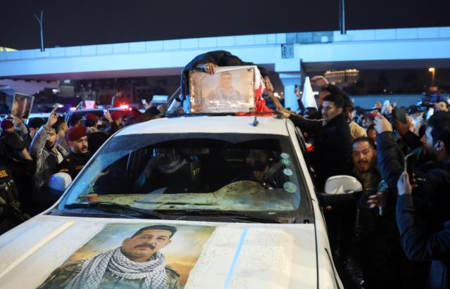 (260313) -- BAGHDAD, March 13, 2026 (Xinhua) -- People attend a funeral for deceased Iraqi paramilitary Popular Mobilization Forces (PMF) members in Baghdad, Iraq, on March 12, 2026. Airstrikes on the 19th Brigade headquarters in Akashat near the Syrian border in Iraq's Anbar province killed at least 32 personnel belonging to the PMF and wounded 65 others on Thursday Morning, a provincial security source told Xinhua on condition of anonymity. (Xinhua/Khalil Dawood)