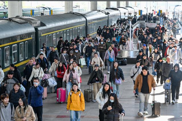 (260313) -- BEIJING, March 13, 2026 (Xinhua) -- Passengers are seen at a platform of Nanjing Railway Station in Nanjing, east China's Jiangsu Province, March 13, 2026. The total number of inter-regional passenger trips across China during the 40-day Spring Festival travel rush, which concluded on Friday, is estimated to reach a record 9.4 billion, according to data from the Ministry of Transport. (Photo by Yang Suping/Xinhua)