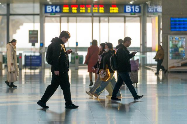 (260313) -- BEIJING, March 13, 2026 (Xinhua) -- Passengers enter the waiting hall of Nanjing South Railway Station in Nanjing, east China's Jiangsu Province, March 13, 2026. The total number of inter-regional passenger trips across China during the 40-day Spring Festival travel rush, which concluded on Friday, is estimated to reach a record 9.4 billion, according to data from the Ministry of Transport. (Photo by Du Yi/Xinhua)