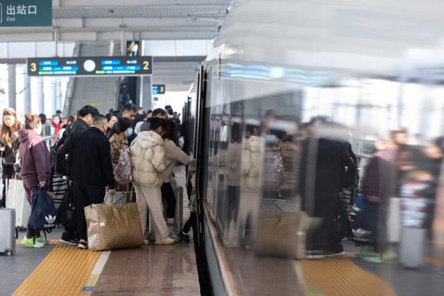 (260313) -- BEIJING, March 13, 2026 (Xinhua) -- Passengers board a train at Huzhou Railway Station in Huzhou, east China's Zhejiang Province, March 13, 2026. The total number of inter-regional passenger trips across China during the 40-day Spring Festival travel rush, which concluded on Friday, is estimated to reach a record 9.4 billion, according to data from the Ministry of Transport. (Photo by Yi Fan/Xinhua)