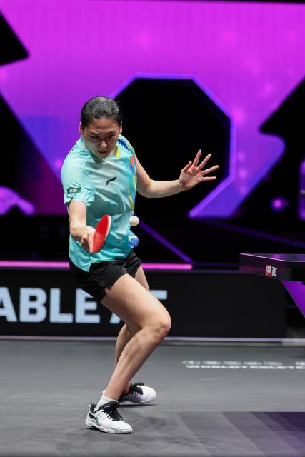 (260313) -- CHONGQING, March 13, 2026 (Xinhua) -- Chen Yi of China hits a return during the women's singles round of 16 match against Bernadette Szocs of Romania at the WTT Champions Chongqing 2026 in southwest China's Chongqing, March 13, 2026. (Xinhua/Huang Wei)