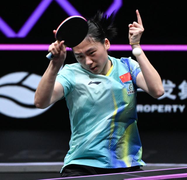 (260313) -- CHONGQING, March 13, 2026 (Xinhua) -- Chen Yi of China hits a return during the women's singles round of 16 match against Bernadette Szocs of Romania at the WTT Champions Chongqing 2026 in southwest China's Chongqing, March 13, 2026. (Xinhua/Chen Cheng)