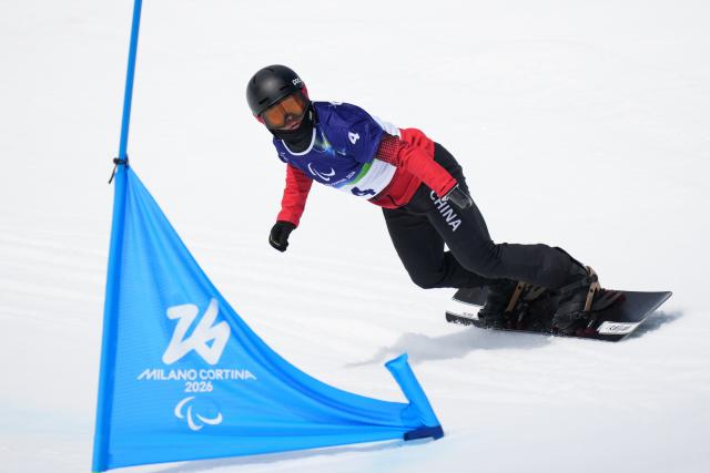 (260313) -- CORTINA D'AMPEZZO, March 13, 2026 (Xinhua) -- Wang Pengyao of China competes during the Para Snowboard Men's Banked Slalom SB-UL event at the Milan-Cortina 2026 Paralympic Winter Games in Cortina D'ampezzo, Italy, March 13, 2026. (Xinhua/Lian Yi)