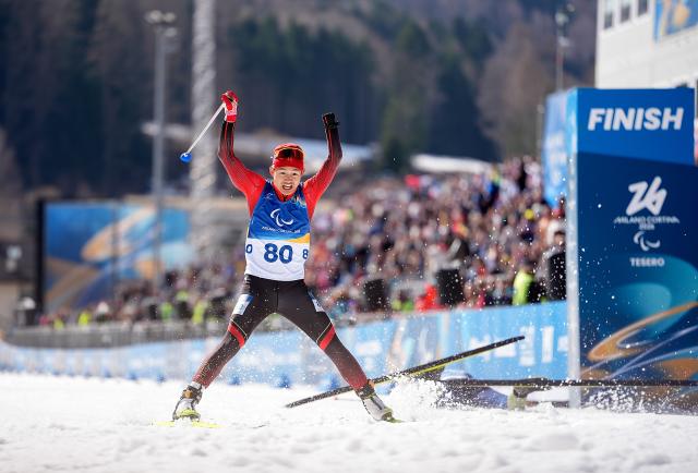 (260313) -- TESERO, March 13, 2026 (Xinhua) -- Cai Jiayun of China celebrates after crowning the para biathlon men's sprint pursuit standing at the Milan-Cortina 2026 Paralympic Winter Games in Tesero, Italy, March 13, 2026. (Xinhua/Hou Zhaokang)