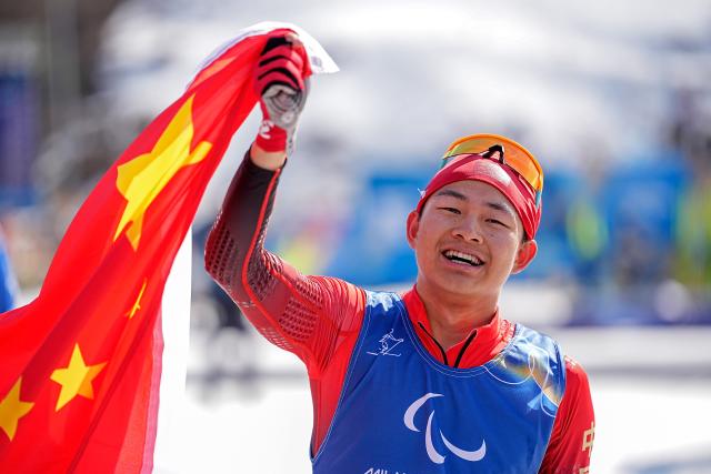 (260313) -- TESERO, March 13, 2026 (Xinhua) -- Cai Jiayun of China celebrates after crowning the para biathlon men's sprint pursuit standing at the Milan-Cortina 2026 Paralympic Winter Games in Tesero, Italy, March 13, 2026. (Xinhua/Hou Zhaokang)
