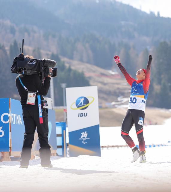 (260313) -- TESERO, March 13, 2026 (Xinhua) -- Cai Jiayun of China celebrates after crowning the para biathlon men's sprint pursuit standing at the Milan-Cortina 2026 Paralympic Winter Games in Tesero, Italy, March 13, 2026. (Xinhua/Hou Zhaokang)
