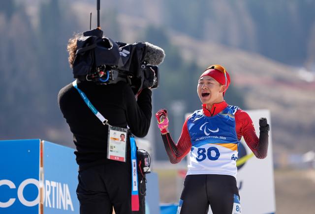 (260313) -- TESERO, March 13, 2026 (Xinhua) -- Cai Jiayun of China celebrates after crowning the para biathlon men's sprint pursuit standing at the Milan-Cortina 2026 Paralympic Winter Games in Tesero, Italy, March 13, 2026. (Xinhua/Hou Zhaokang)
