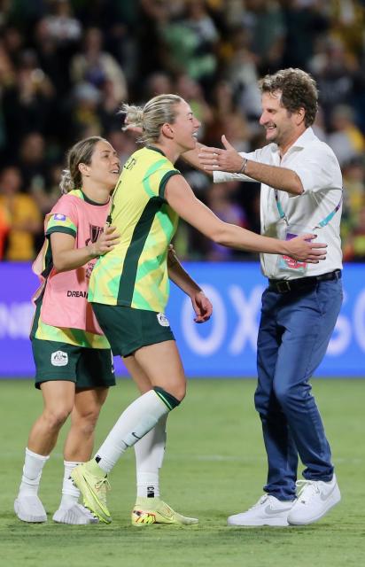 (260313) -- PERTH, March 13, 2026 (Xinhua) -- Joseph Montemurro (R), head coach of Australia, celebrates with players after winning the quarterfinal of Women's Asian Cup between Australia and the Democratic People's Republic of Korea (DPRK) at Perth Rectangular Stadium in Perth, Australia, March 13, 2026. (Photo by Zhou Dan/Xinhua)