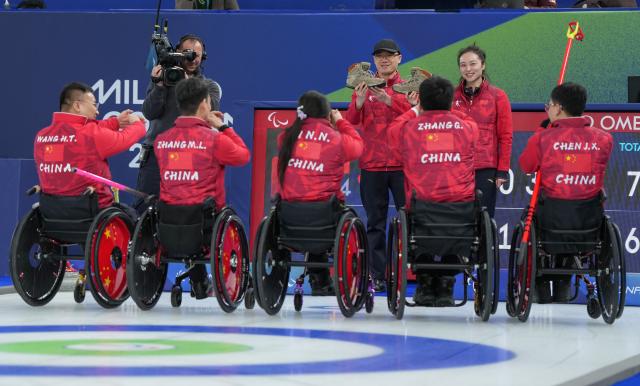 (260313) -- CORTINA D'AMPEZZO, March 13, 2026 (Xinhua) -- Team China celebrate after winning the wheelchair curling mixed team semifinal match between China and Sweden at the Milan-Cortina 2026 Paralympic Winter Games in Cortina D'ampezzo, Italy, March 13, 2026. (Xinhua/Wang Kaiyan)
