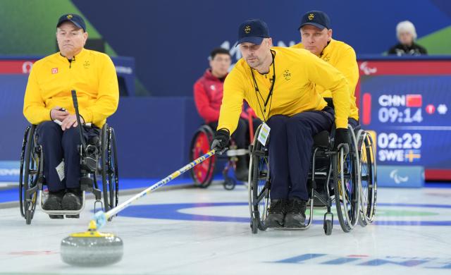 (260313) -- CORTINA D'AMPEZZO, March 13, 2026 (Xinhua) -- Viljo Petersson Dahl (front) of Sweden competes during the wheelchair curling mixed team semifinal match between China and Sweden at the Milan-Cortina 2026 Paralympic Winter Games in Cortina D'ampezzo, Italy, March 13, 2026. (Xinhua/Wang Kaiyan)
