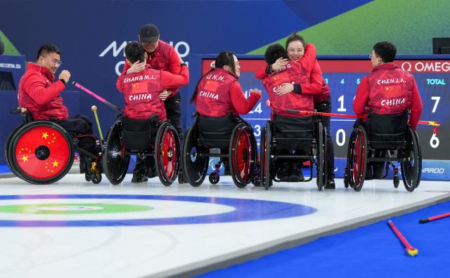 (260313) -- CORTINA D'AMPEZZO, March 13, 2026 (Xinhua) -- Team China celebrate after winning the wheelchair curling mixed team semifinal match between China and Sweden at the Milan-Cortina 2026 Paralympic Winter Games in Cortina D'ampezzo, Italy, March 13, 2026. (Xinhua/Wang Kaiyan)